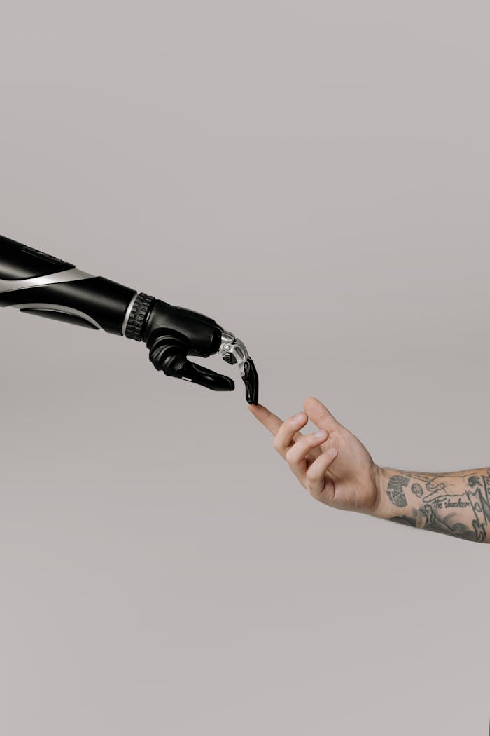Crafting Captivating Headlines: Your awesome post title goes here Close-up of a prosthetic arm and a human hand reaching towards each other in harmony.