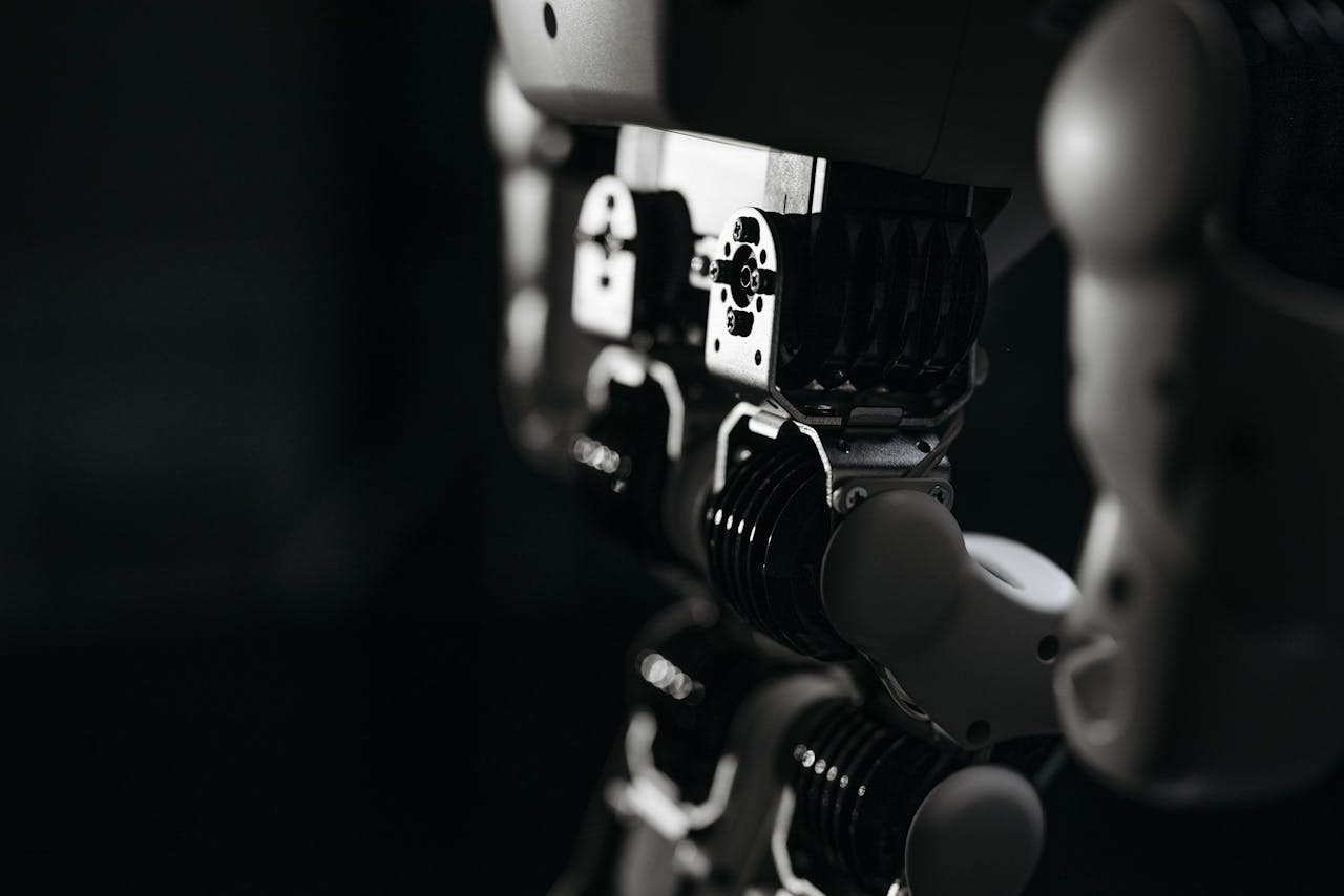 about-img Detailed close-up of a robot's mechanical components, emphasized by moody studio lighting.
