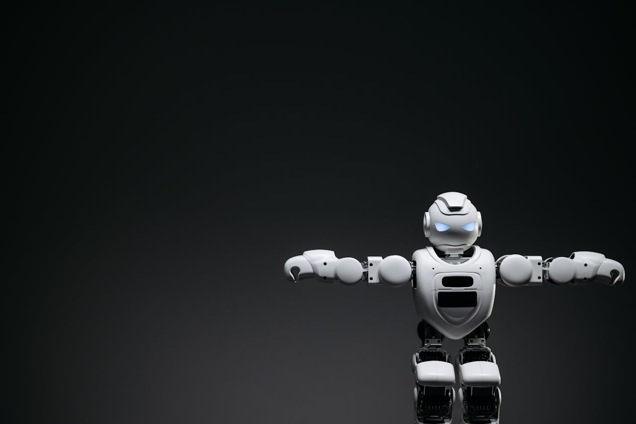 our-experience Studio shot of a humanoid robot with glowing eyes against a dark background, offering ample copyspace.